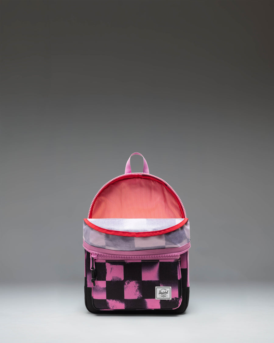 Herschel Heritage Kids Backpack in Stencil Checker Opera Mauve, featuring a pink checkered pattern with stencil text details.