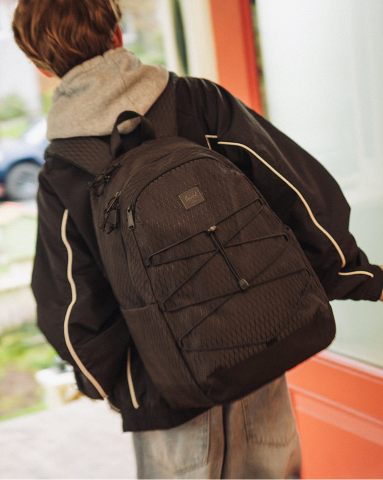 Herschel Kingston Backpack in Black Diamond/Black featuring a sporty silhouette, front bungee cord system, and dual water bottle pockets.